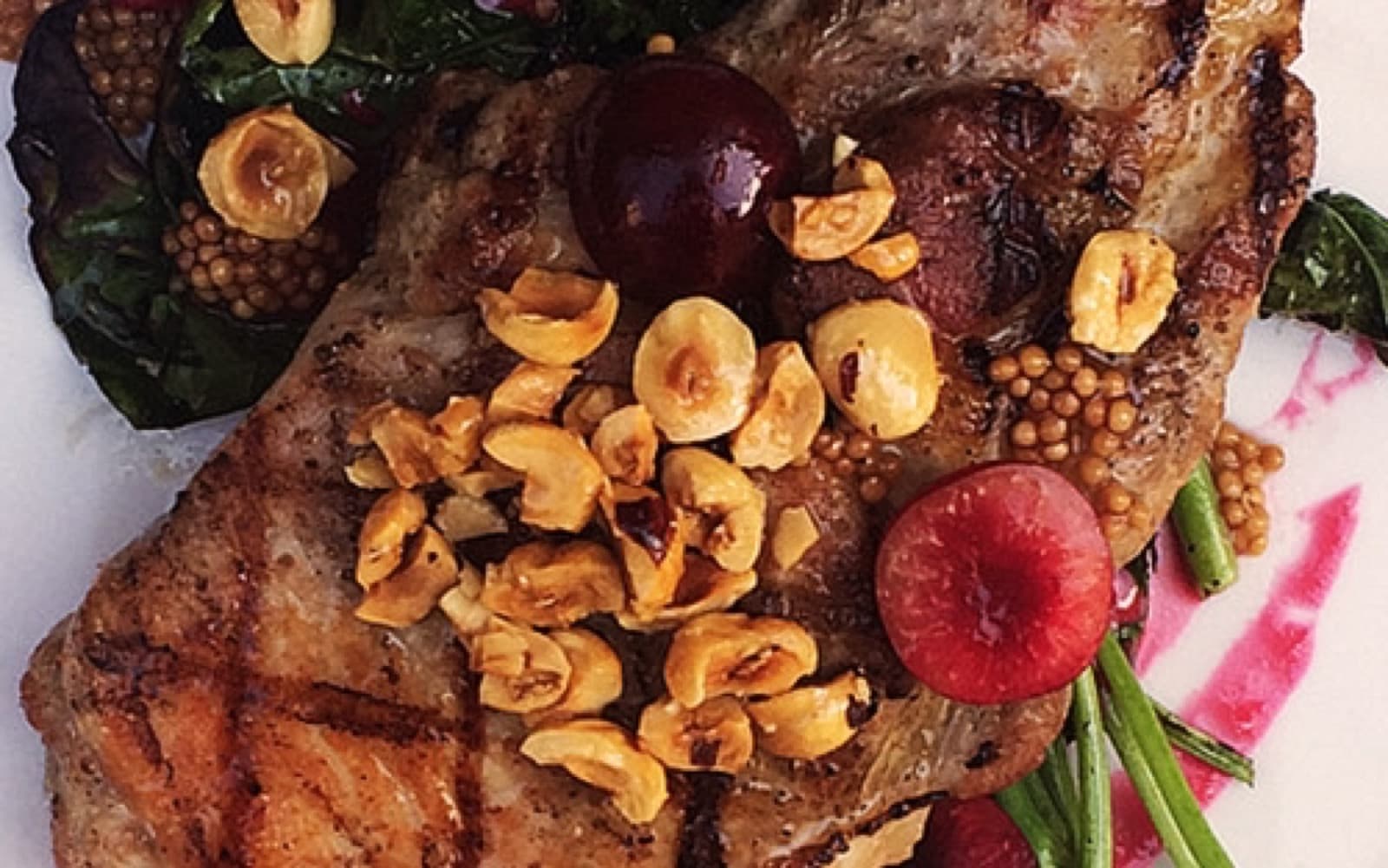 Bix grilled pork chop with toasted hazelnuts and mustard